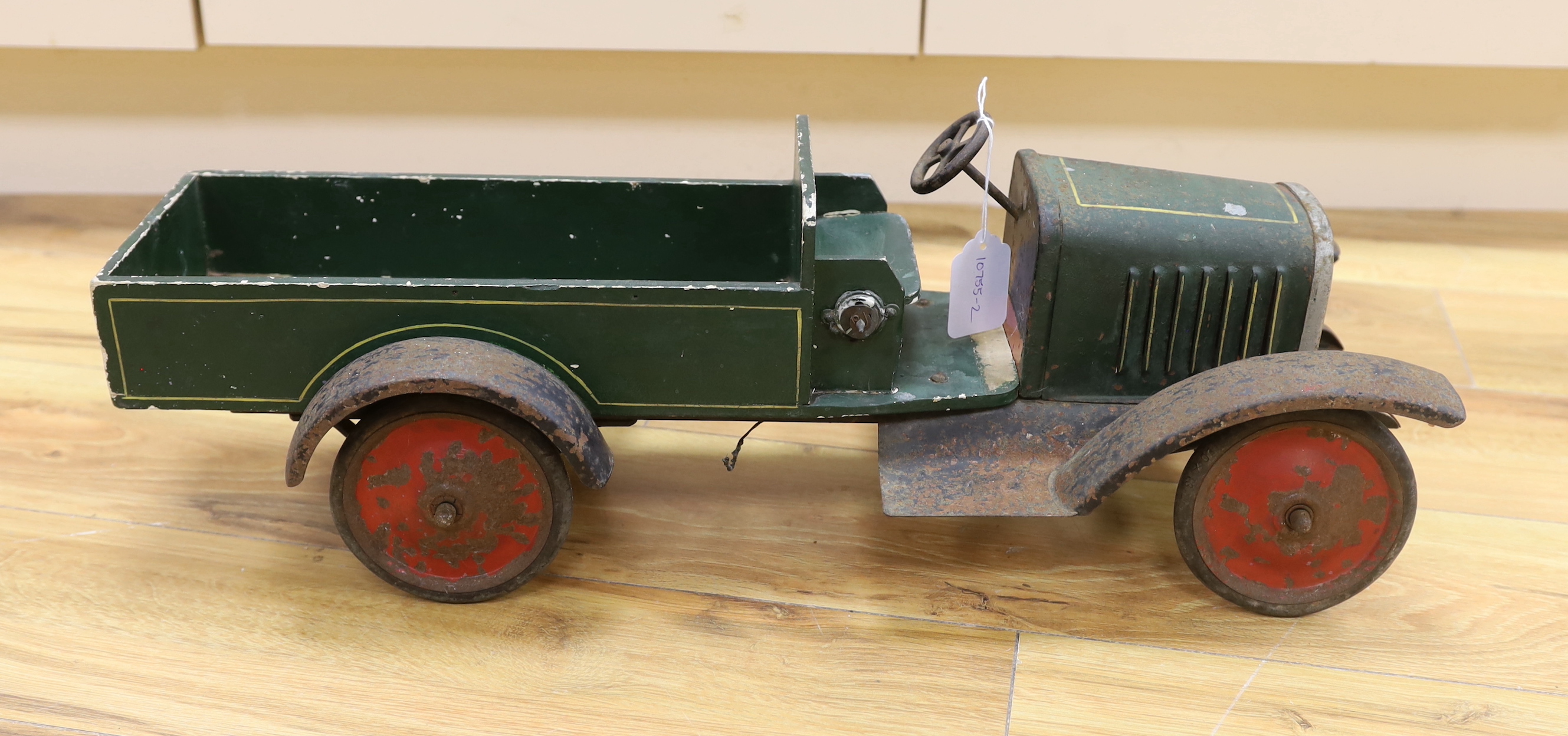 A large 1920s style tinplate and wood truck, length 62.5cm
